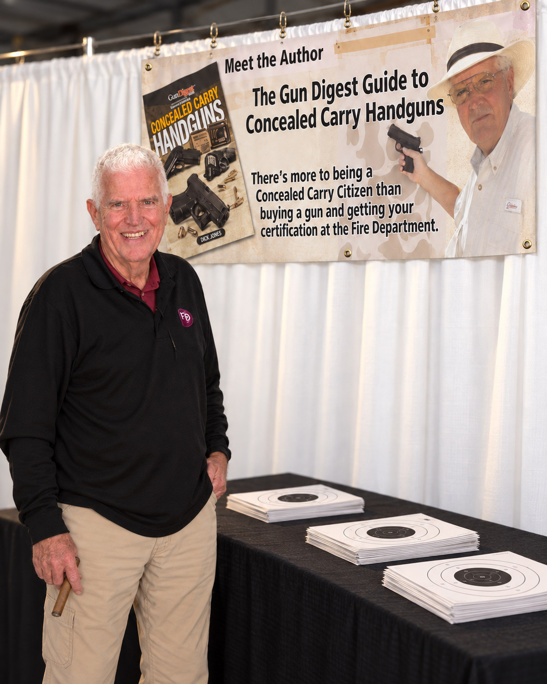 Dick Jones standing beside a Meet the Author display for his Gun Digest Guide to Concealed Carry Handguns