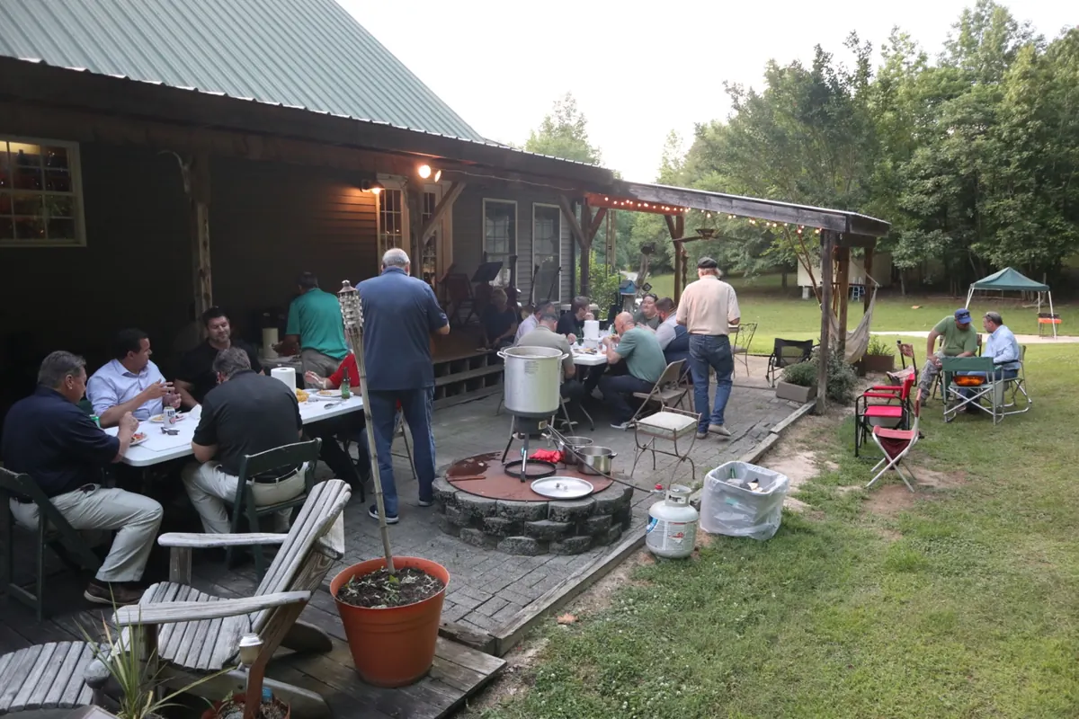 A group gathering outdoors at Lewis Creek