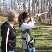 Two women practicing shotgun wingshooting at Lewis Creek